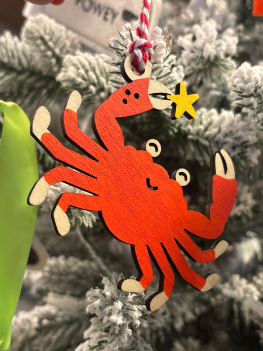 wooden crab Christmas ornament painted orange with yellow starfish, whimsical coastal holiday tree decoration