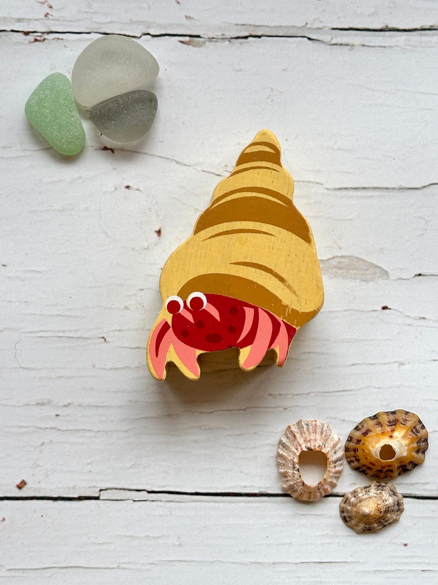 painted wooden hermit crab toy with spiral shell, beach-themed coastal decor for kids and ocean lovers