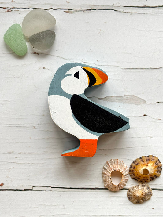 painted wooden puffin toy with bright beak and feet, coastal animal decor for beach-themed play or display