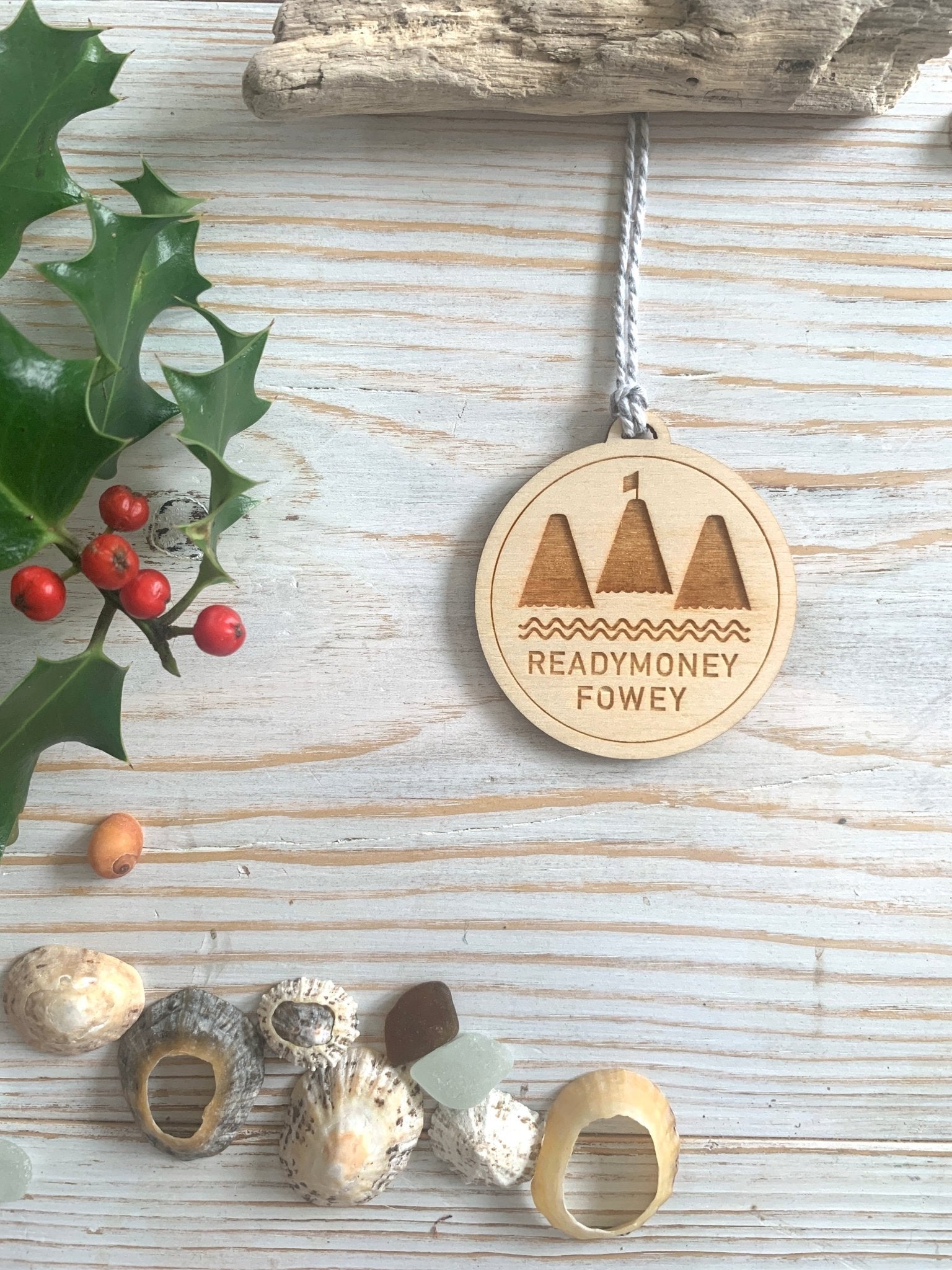 engraved round wooden Readymoney Fowey ornament, coastal holiday decor with mountain and sea motif