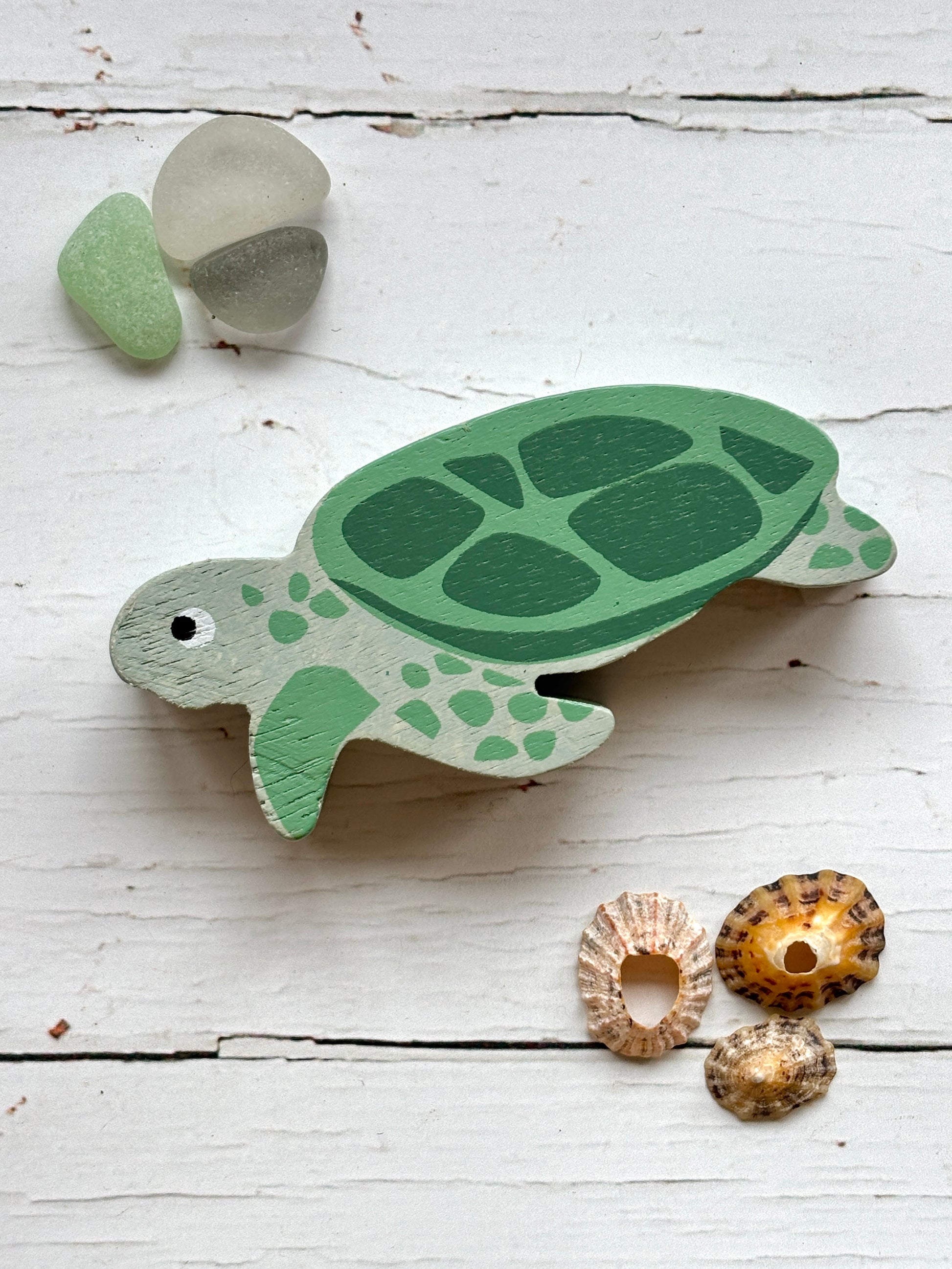 painted wooden sea turtle toy with green shell, beach-themed coastal decor for ocean-inspired play and display