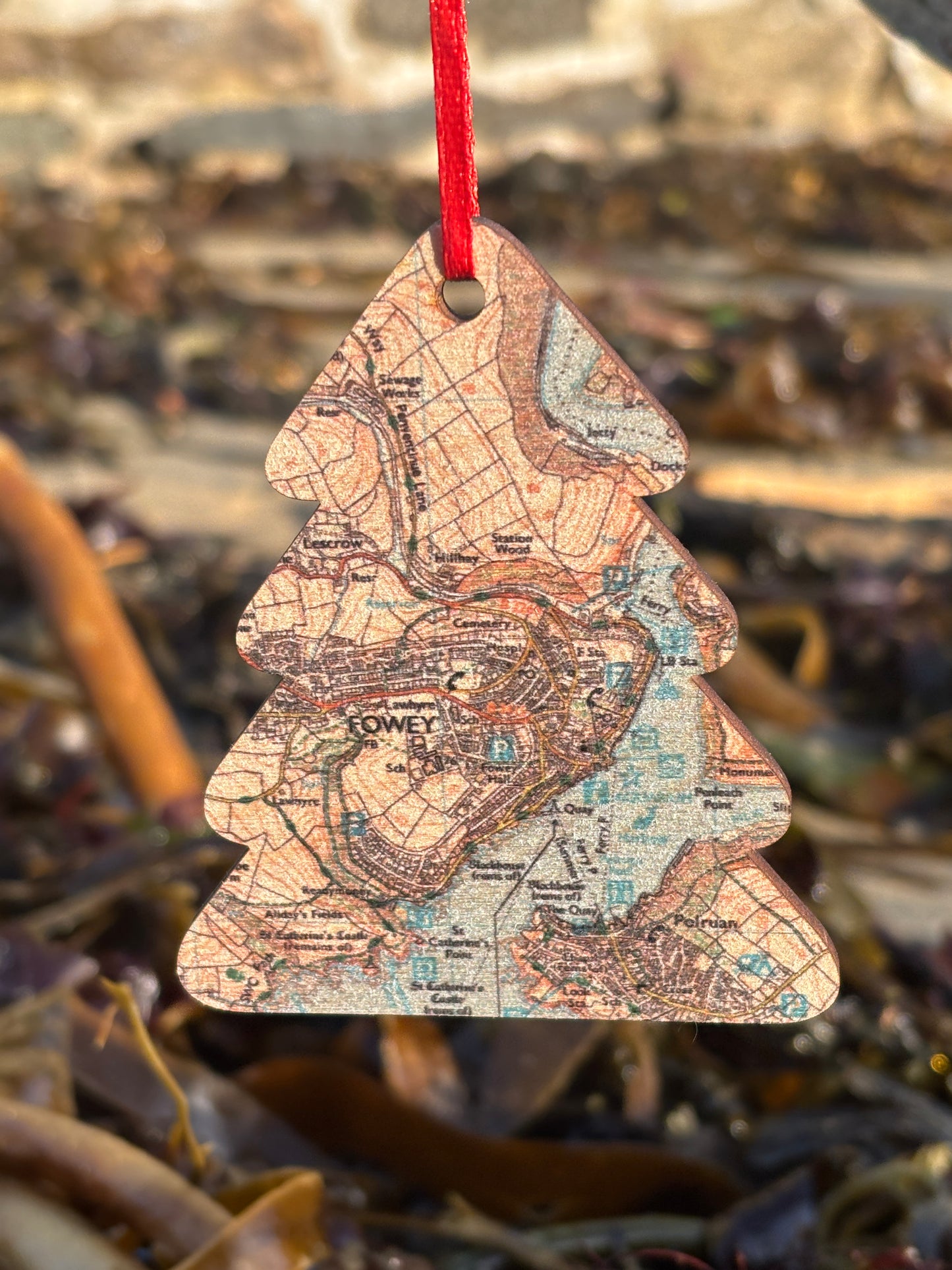 a wooden christmas tree shaped decoration featuring a map of fowey