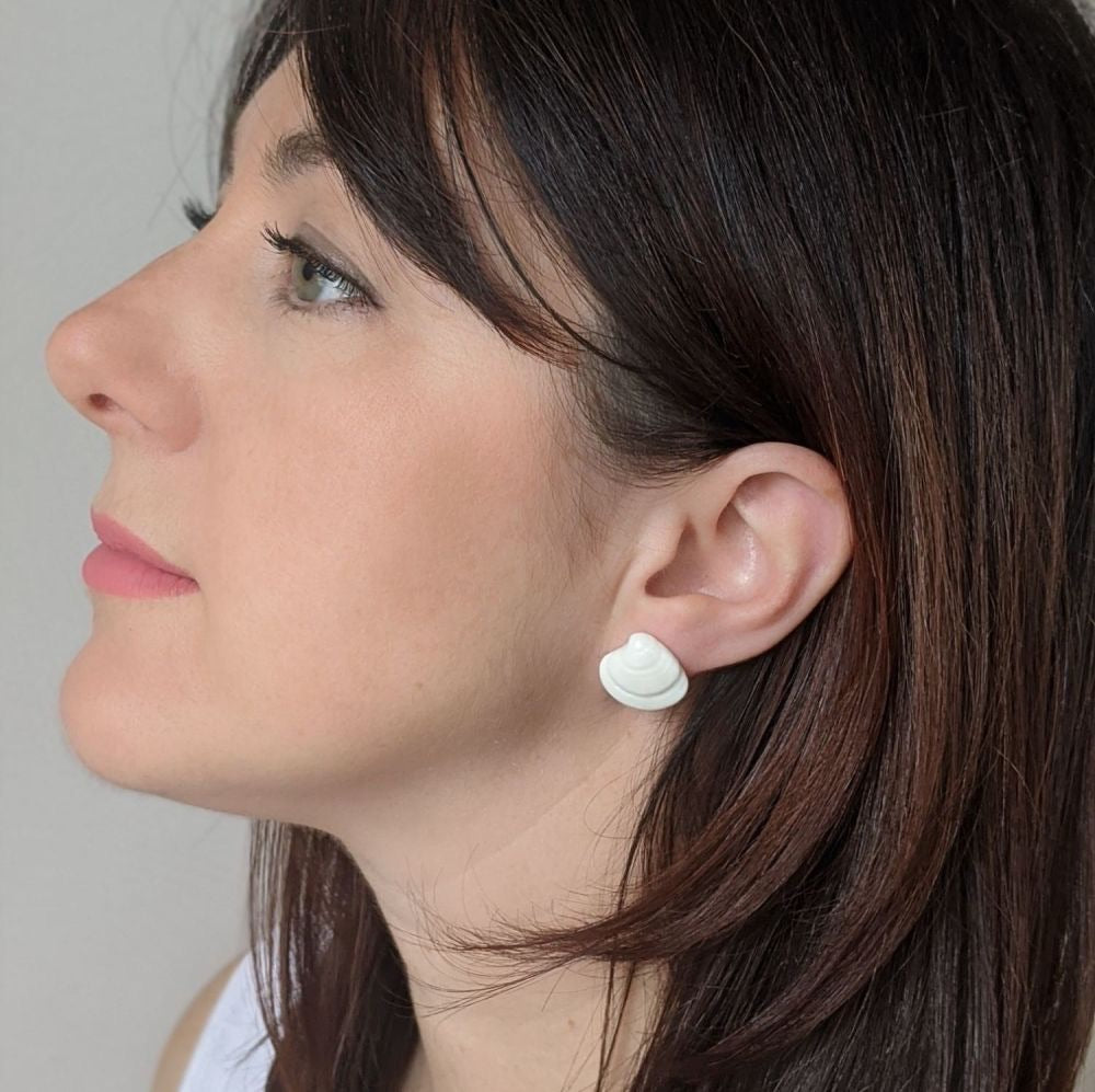 woman wearing porcelain clam shell stud earrings