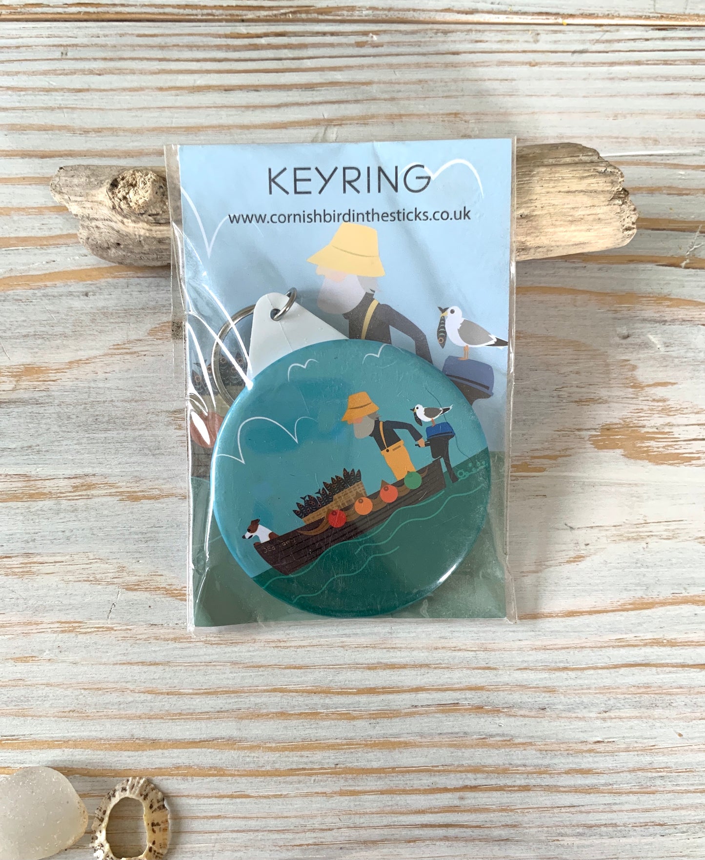 Colourful key-ring depicting a fisherman and his dog on a boat