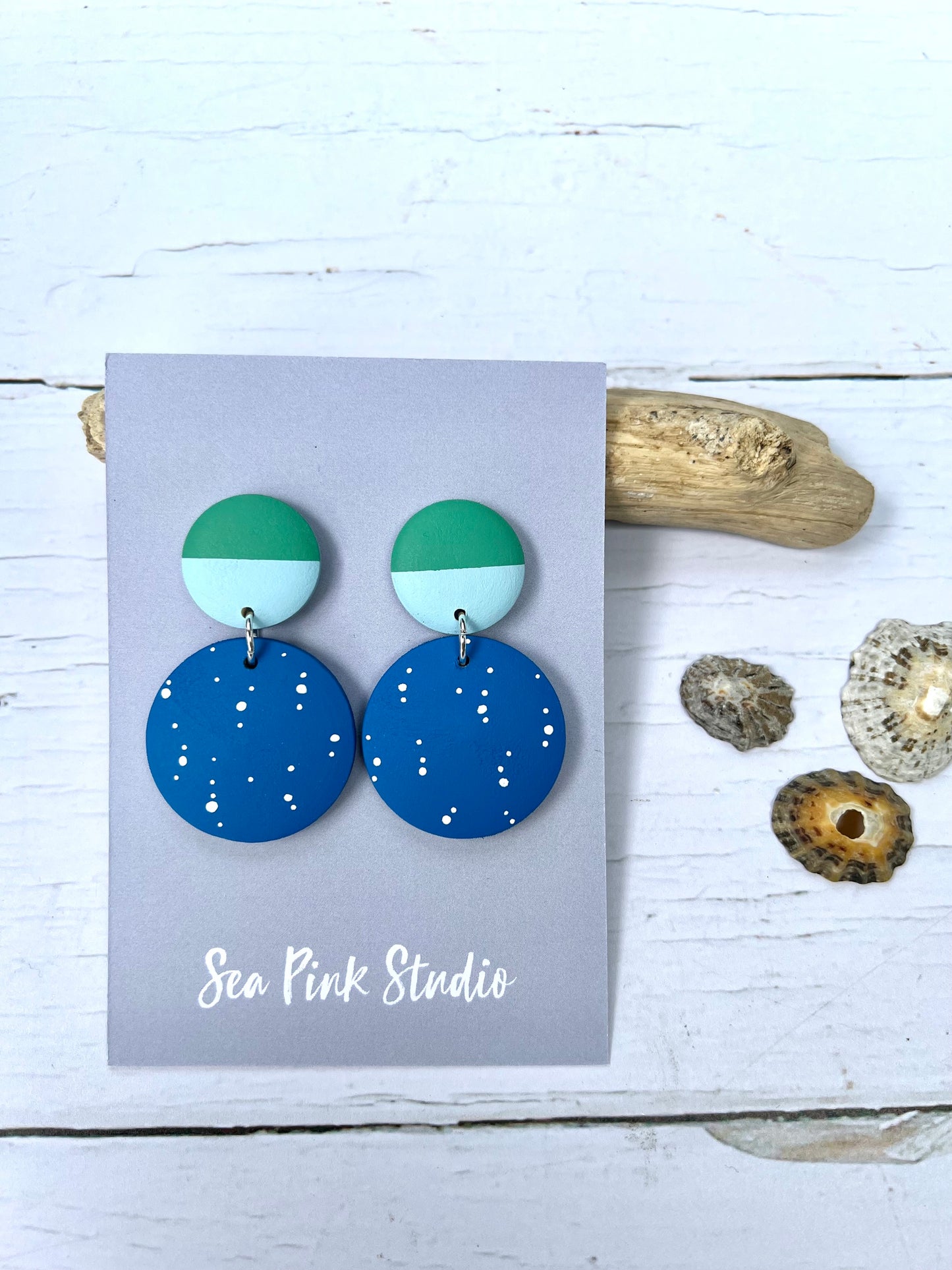 Handpainted blue earrings with white spots and green tops